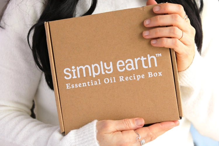 Hands holding the Simply Earth Essential Oil Recipe Box