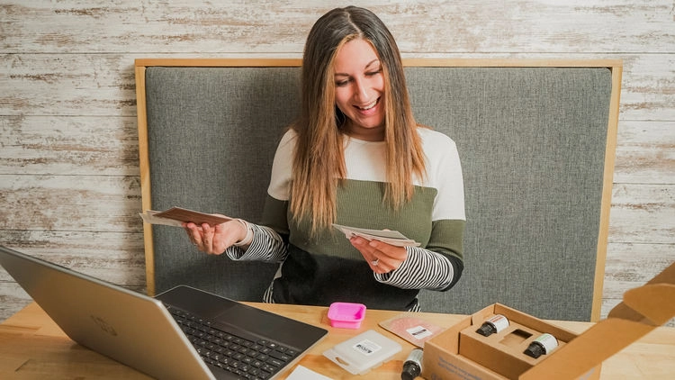 A team member at a laptop with a recipe box open