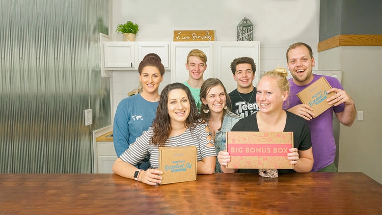 The Simply Earth team posing around a table with recipe boxes