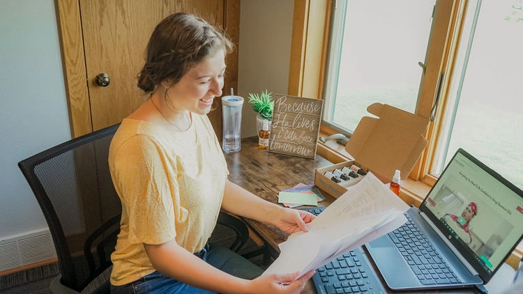 Woman reading a recipe page at a desk