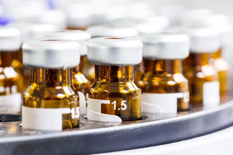 Rows of amber glass vials in a lab tray