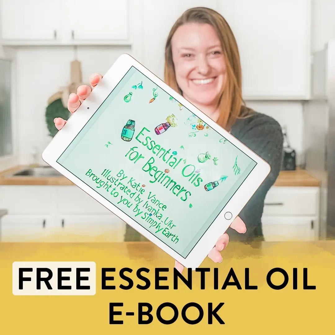 Woman holding a tablet showing the Essential Oils for Beginners free e-book