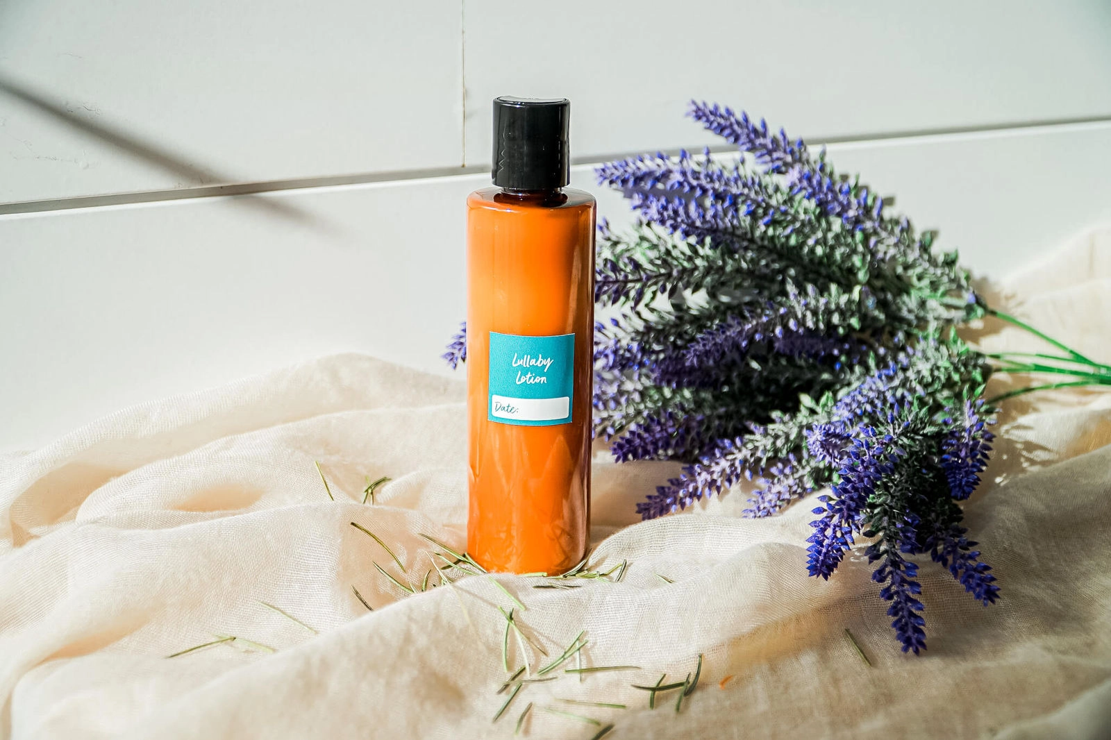 Lullaby Lotion bottle beside fresh lavender