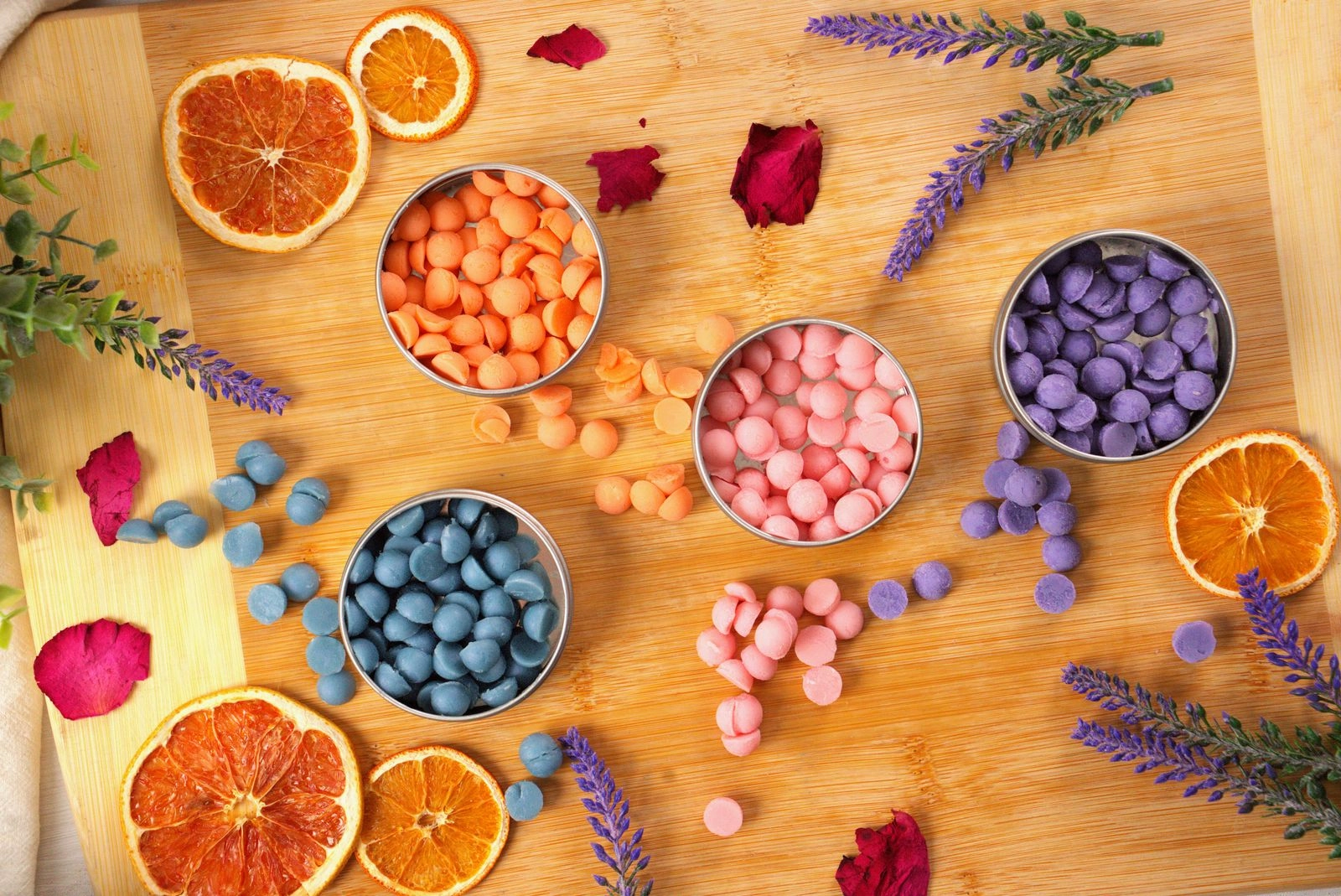 Lotion Dots in small tins surrounded by dried orange slices